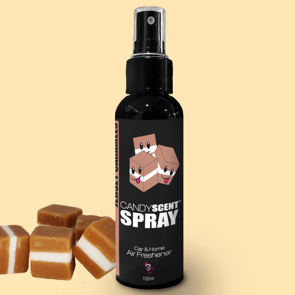 A black spray bottle of CANDYSCENT™ Car & Home Scent Sprays, labeled as a car and home air freshener, is displayed. The bottle features a cute cartoon candy design on the label. To the left of the bottle, there are caramel candy pieces with white layers. The 125ml bottle promises to eliminate odors.