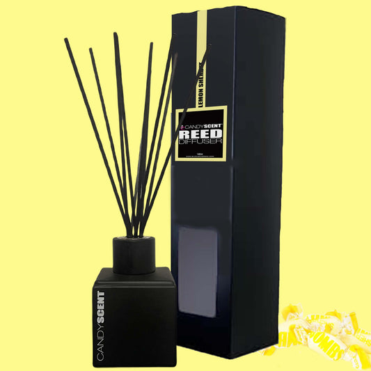 A CANDYSCENT™ reed diffuser, featuring black reeds and a sleek bottle, is elegantly displayed against a yellow background alongside its complementary black box. The product prominently showcases the "CANDYSCENT" label, with delightful fragrances seemingly emanating from the charming small candy illustrations in the corner.