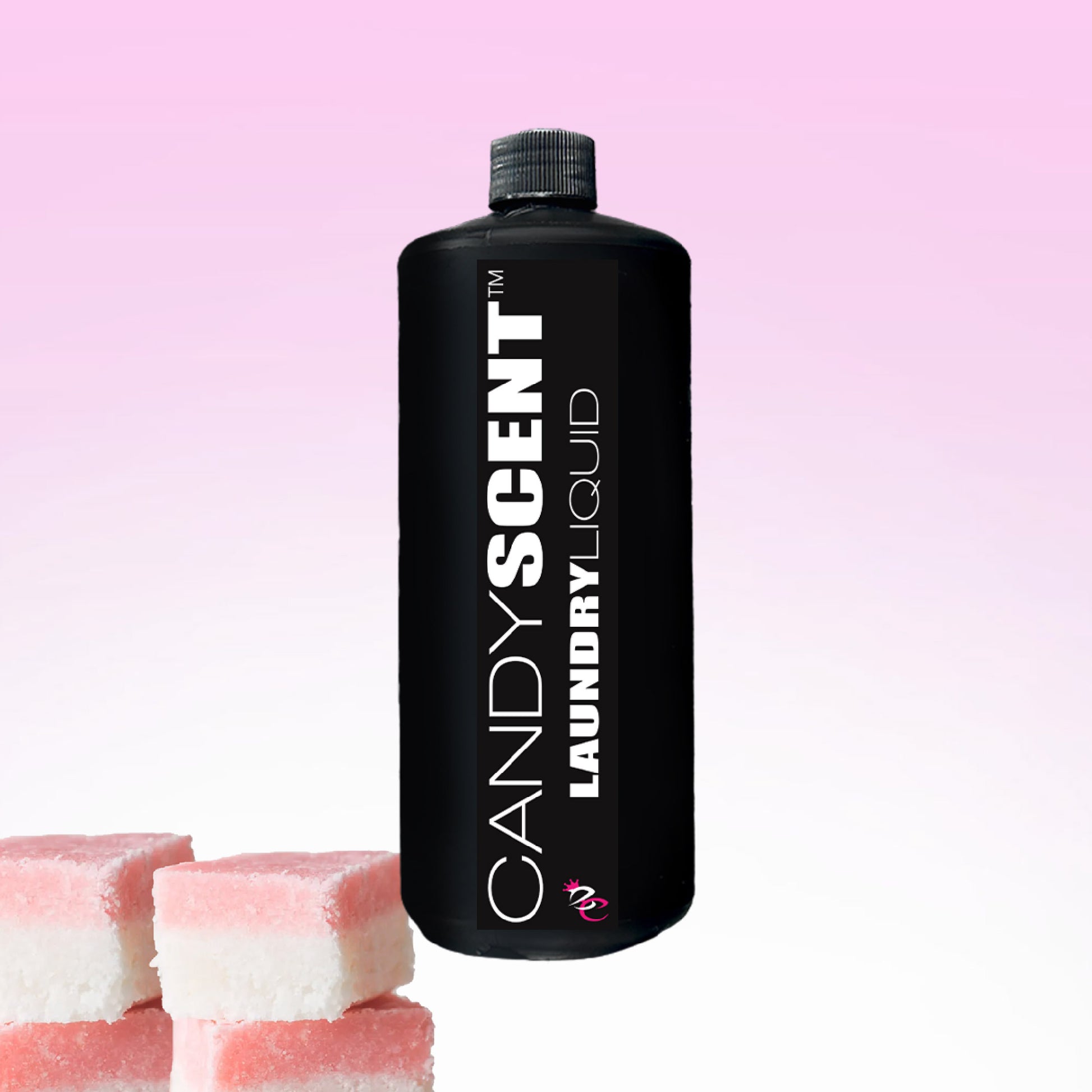 A black bottle labeled "CANDYSCENT™ Laundry Liquid" stands proudly against a pink and white gradient background, bringing eco-friendly charm to your routine. Three pink and white candy squares are playfully positioned in the lower left corner, enhancing the whimsical display.