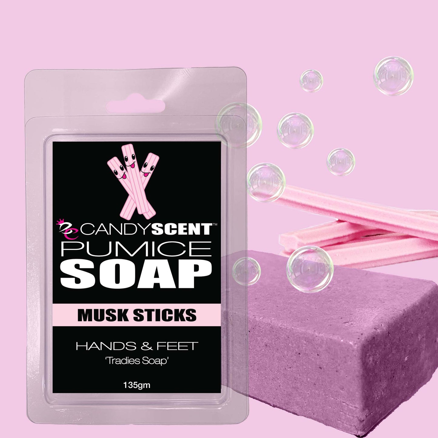 The image shows a 135g package of CANDYSCENT™ Pumice Soap with a musk stick scent, designed for hands and feet. This exfoliating soap is perfect for tradies. The black package prominently displays the product name in white and pink text, along with an illustration of pink musk sticks. The background is light pink with soap bubbles.