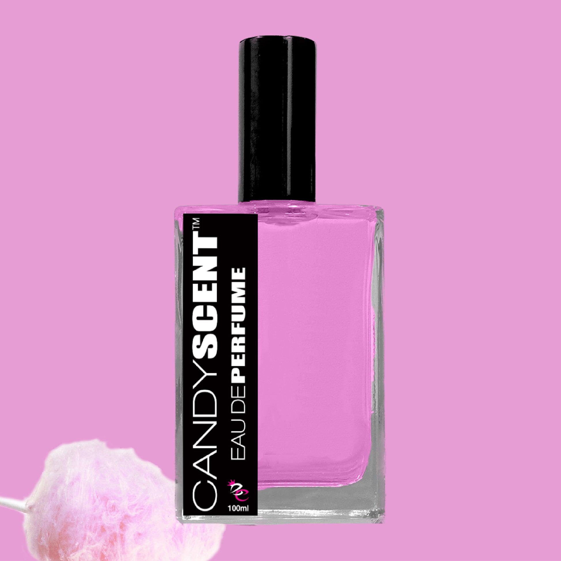 A rectangular perfume bottle with a black cap contains pink liquid. The label displays "CANDYSCENT™ Eau De Perfume / Cologne" in bold white letters on a black background. A piece of cotton candy adorns the bottom left corner, all set against a pink backdrop, invoking scents of sweet playfulness and sugary delights.