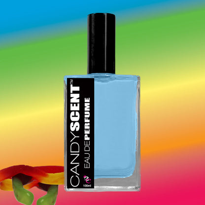 A square perfume bottle from CANDYSCENT™ with a black cap and a label reading "Eau De Perfume / Cologne" contains a light blue liquid. The background showcases a vibrant gradient of blue, green, yellow, and red hues. A colorful gummy worm is partly visible at the bottom left, evoking sweet and playful fragrances.