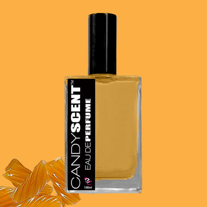 A rectangular glass bottle of "CANDYSCENT™ Eau De Perfume / Cologne" with a black label and cap against an orange background. The label features the text “CANDYSCENT™” and “Eau De Perfume / Cologne.” Orange candy-like pieces in the bottom left corner hint at the sweet fragrance, perfect for everyday wear.