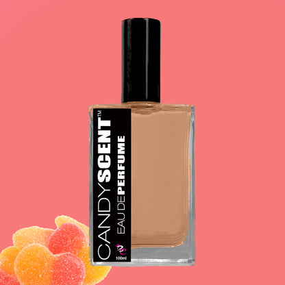 A rectangular glass bottle of Eau De Perfume / Cologne by CANDYSCENT™ with a black cap, set against a pink background. At the bottom left, colorful, sugar-coated gummy heart candies perfectly capture the essence of sweet playful fragrances ideal for everyday wear.