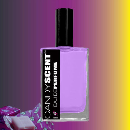 A bottle of CANDYSCENT™ Eau De Perfume / Cologne contains a purple liquid, featuring a black label with white text. The bottle cap is also black. The background showcases a gradient of colors from purple to yellow, and in the bottom left corner, there's a piece of wrapped candy. Perfect for everyday wear, this sweet perfume captivates the senses.