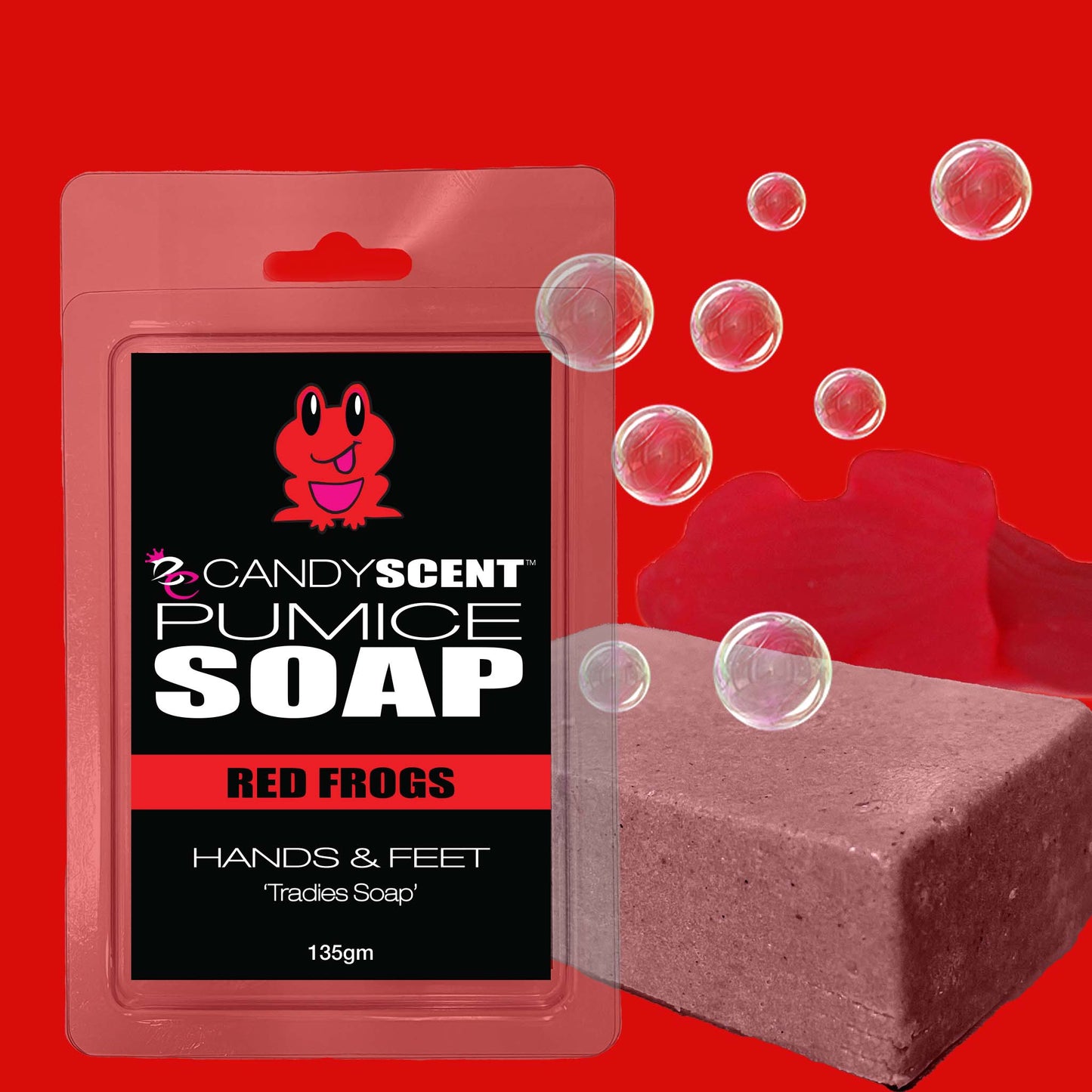 A bar of CANDYSCENT™ Pumice Soap is shown in a plastic package labeled "Red Frogs, Hands & Feet, Exfoliating Tradies Soap." The packaging features an image of a smiling red frog. Next to it, an unwrapped brownish soap bar with bubbles around it is displayed. The background is red.