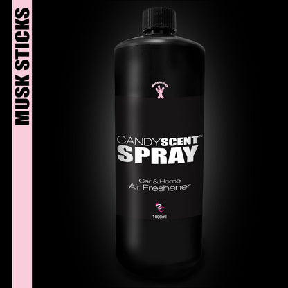 The elegant black bottle of CANDYSCENT™ Car & Home Scent Sprays contrasts with the dark background. Featuring a pink "Musk Sticks" label, it offers a sweet scent and enduring fragrance with its ample 1000 ml capacity.