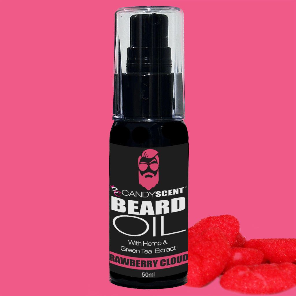 A black and pink bottle of CANDYSCENT™ Beard Oil, featuring labels "With Hemp & Green Tea Extract" and "Strawberry Cloud," is set against a pink background. Nearby, two heart-shaped gummy candies highlight the grooming essential's promotion of optimal beard health.