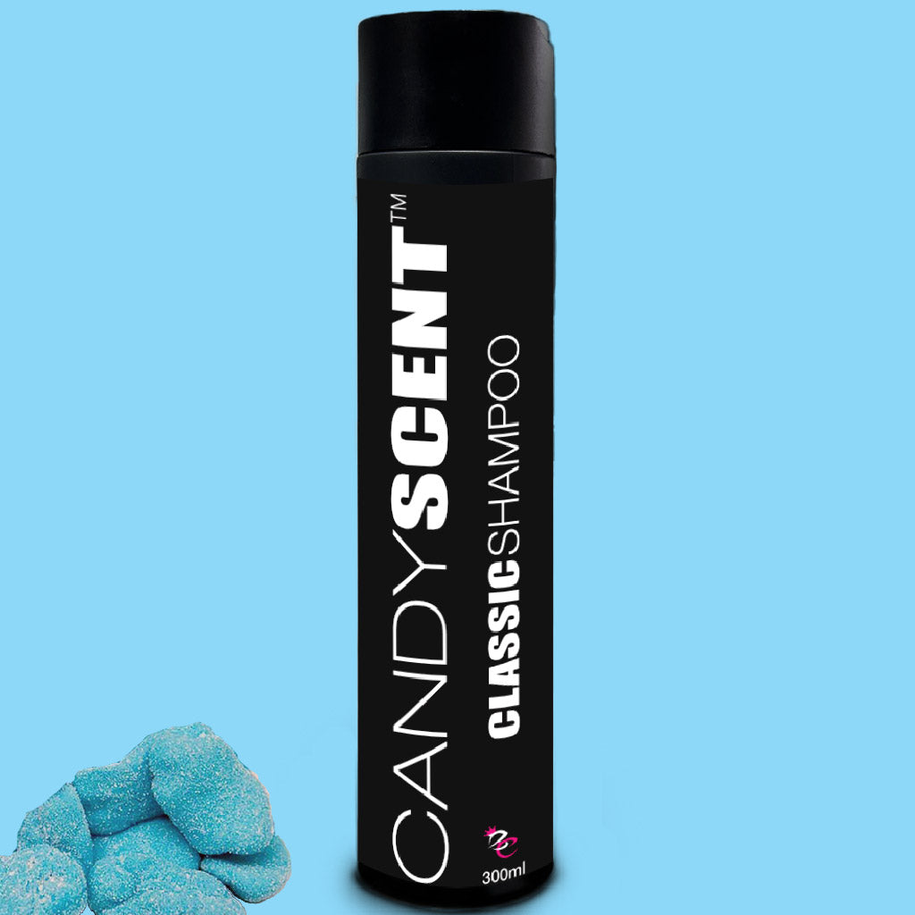 A 300ml bottle of CANDYSCENT™ Classic Shampoo featuring a black label with white text is set against a light blue background. This luxurious hair care shampoo stands out prominently, and in the bottom left corner, a few blue, sugar-coated gummy candies are visible.