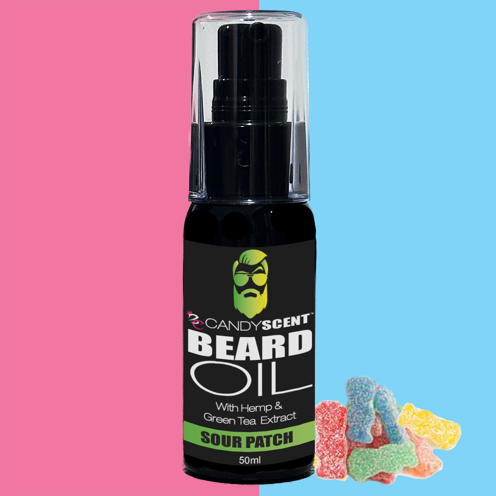 A black bottle of CANDYSCENT™ Beard Oil with a green label that reads "Candy Scent Beard Oil with Hemp & Green Tea Extract - Sour Patch 50ml" is centered against a backdrop that transitions from pink to blue. Assorted colorful gummy candies are arranged nearby, making it an ideal addition to your grooming essentials and promoting beard health.