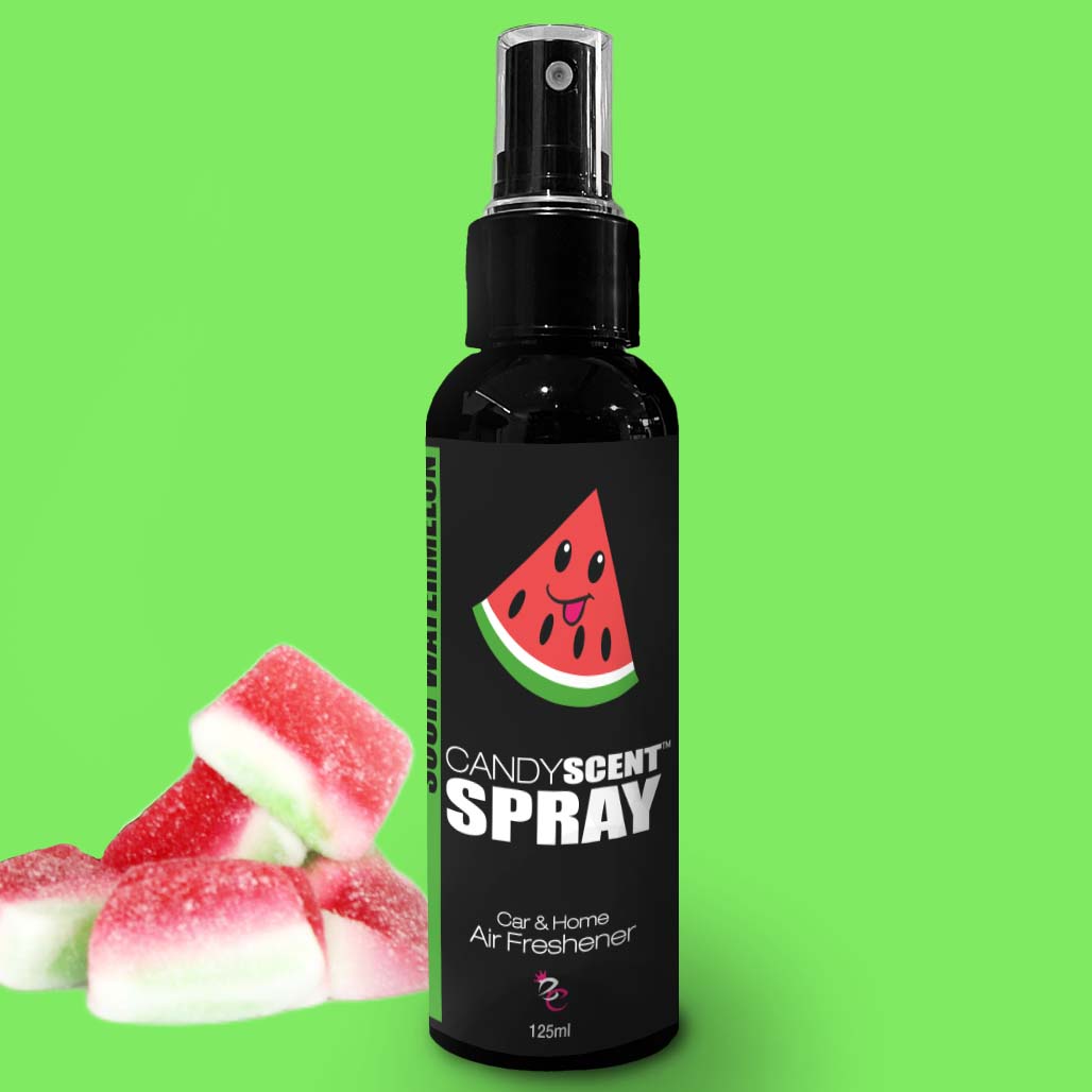 A black spray bottle labeled "CANDYSCENT™ Car & Home Scent Sprays," featuring a smiling watermelon graphic, is set against a vibrant green background. To the left of the bottle, several red and green watermelon-shaped gummy candies are displayed. The 125ml bottle provides a long-lasting fragrance for both car and home air freshening.