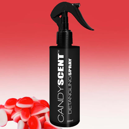 A black spray bottle labeled "CANDYSCENT™ Hair Detangling Spray 200ml" stands against a gradient red and white background. Infused with Jojoba Oil, it promises smooth, manageable hair. In the foreground, there are small candy-shaped objects in red and white.