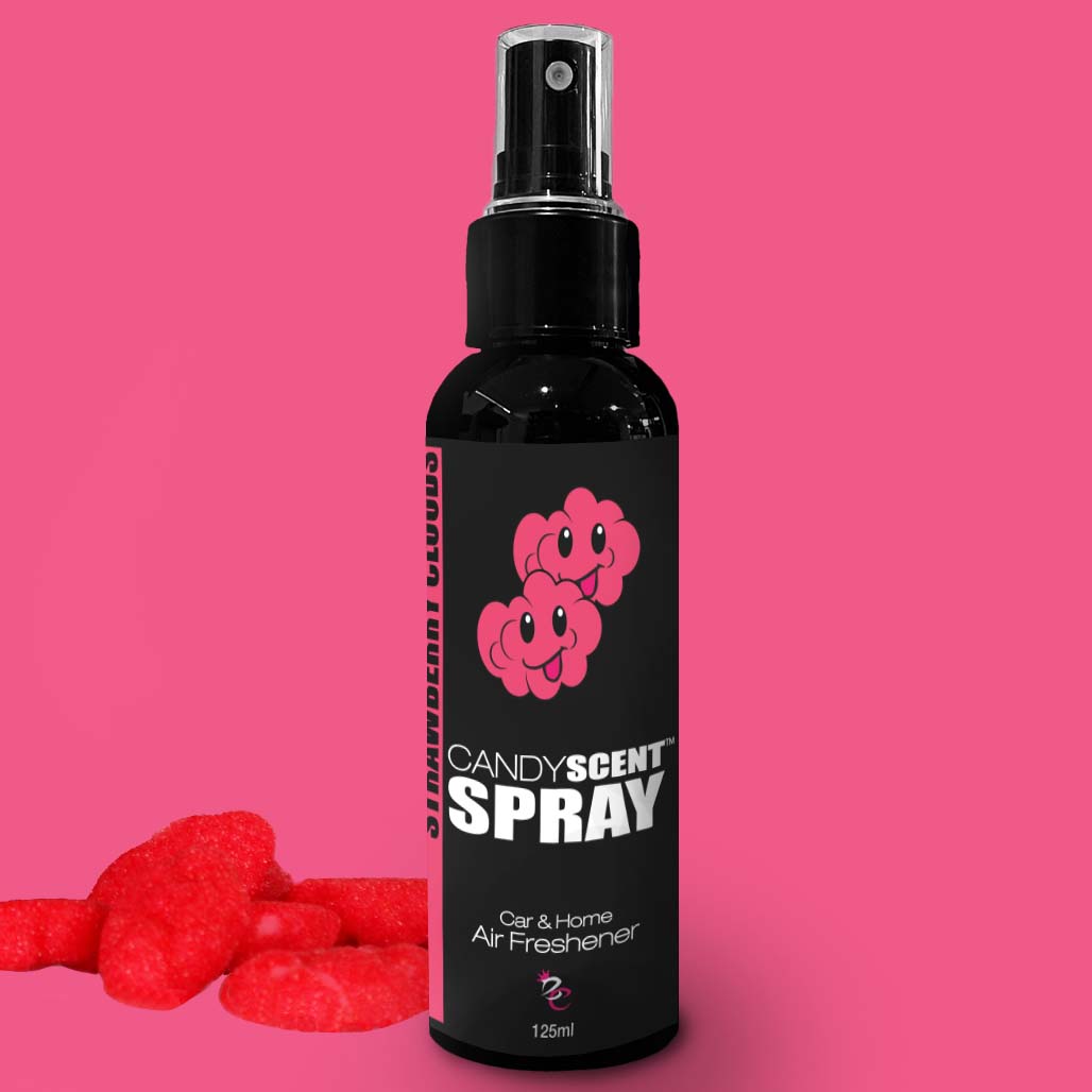 A black spray bottle labeled "CANDYSCENT™ Car & Home Scent Sprays" with a cartoon image of two pink candies is set against a pink background. The long-lasting fragrance bottle, ideal for eliminating odors, is surrounded by several red, sugar-coated gummy candies.