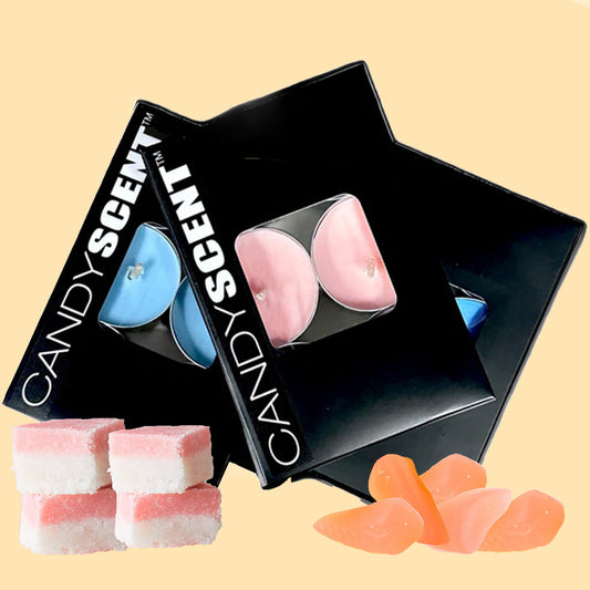 Two black boxes with "CANDYSCENT™" printed on them, each containing two Scented Tealight Candles, one in blue and one in pink. Beside the boxes, there are five pieces of pink-and-white striped candy and a few orange gummy candies on a light beige background.