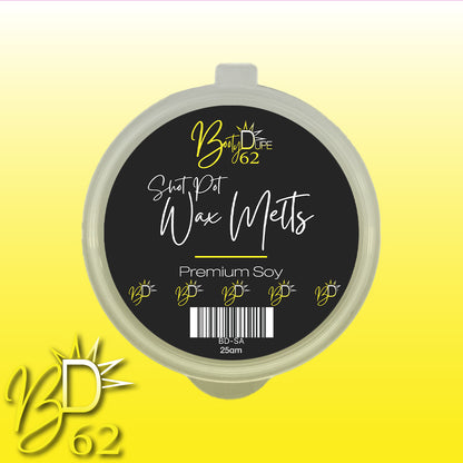 A circular container labeled "Soy Wax Melts" from BOOTY DUPE features a black lid with yellow text and accents. The container sits on a gradient yellow background with the brand's logo, "BOOTY DUPE," prominently displayed in the bottom left corner. These highly scented wax melts promise a long-lasting aroma.