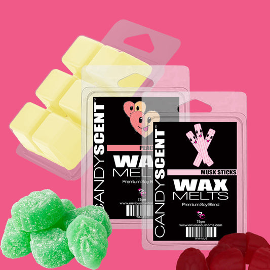 The image showcases two packages of CANDYSCENT™ Wax Melts on a pink backdrop. One pack, labeled "Peach" with an adorable bear graphic, and the other labeled "Musk Sticks." Surrounding the packages are yellow wax melts, green sugar-coated candies, and reddish-purple gummy bears—creating a fragrant paradise.