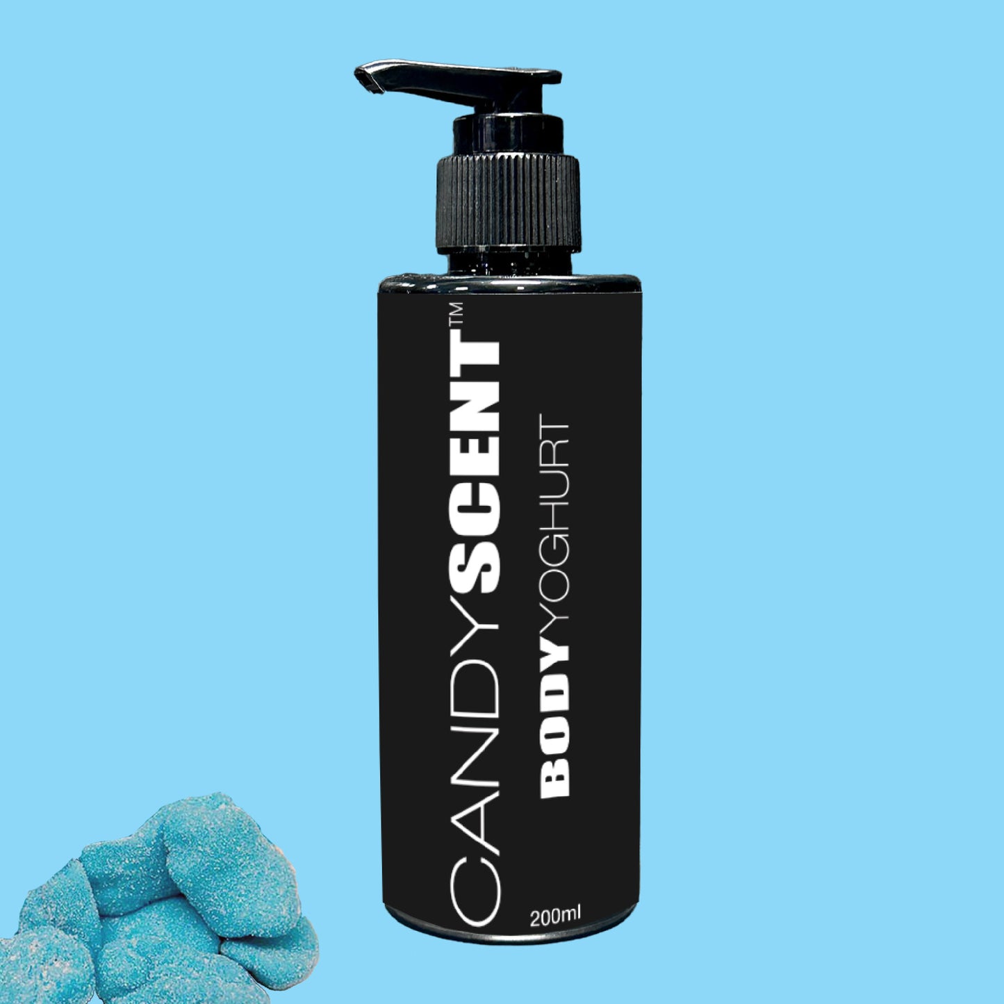 A black bottle labeled "CANDYSCENT™ Body Yoghurt" with a pump top stands against a light blue background, promising deep hydration. Small blue candies are strategically placed in the lower left corner, enhancing the nourishing experience of this visually appealing image.