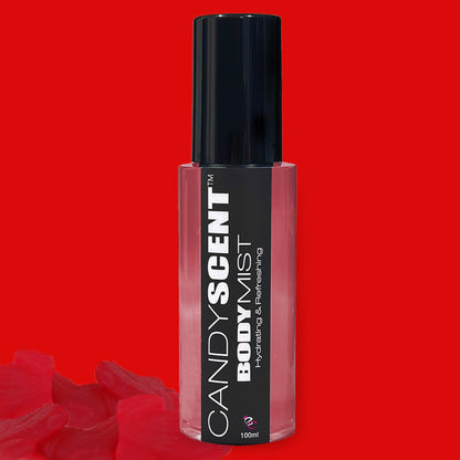 A bottle of Hydrating Body Mist from CANDYSCENT™ is showcased against a vibrant red background, with a few red candy shapes adorning the bottom of the image. The label highlights it as "Hydrating & Refreshing," enriched with nourishing ingredients like witch hazel. The elegant bottle features a black cap and clear body that reveals the pink liquid inside.